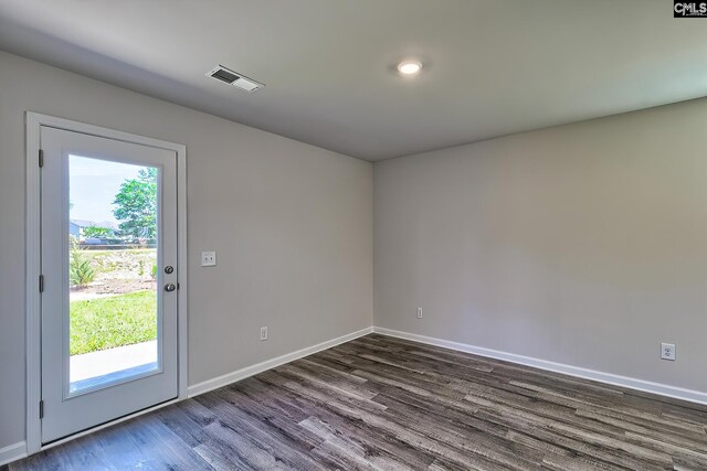 empty room with dark hardwood / wood-style flooring