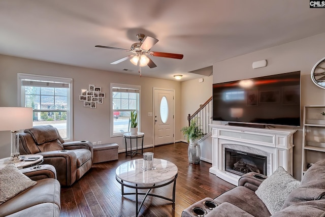 living room featuring ceiling fan, dark wood-type flooring, and a high end fireplace