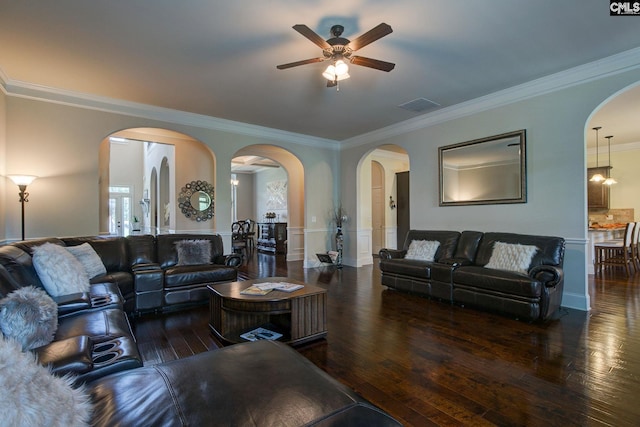 living room featuring ceiling fan, dark wood-type flooring, and crown molding