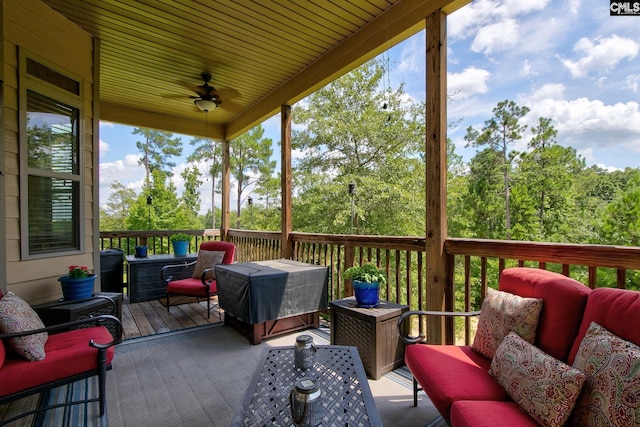 wooden deck with ceiling fan and an outdoor hangout area