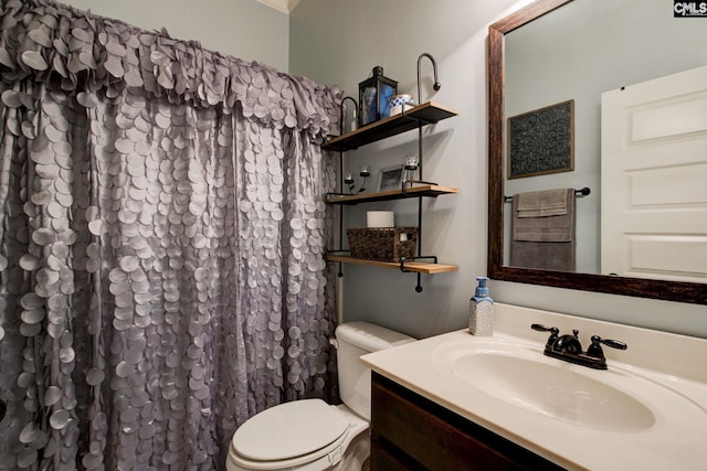 bathroom featuring vanity, toilet, and walk in shower
