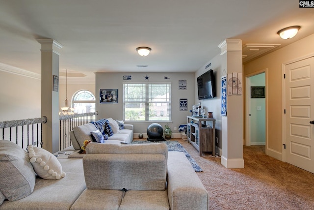 carpeted living room with crown molding and ornate columns