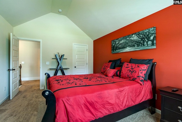 bedroom with vaulted ceiling and carpet floors