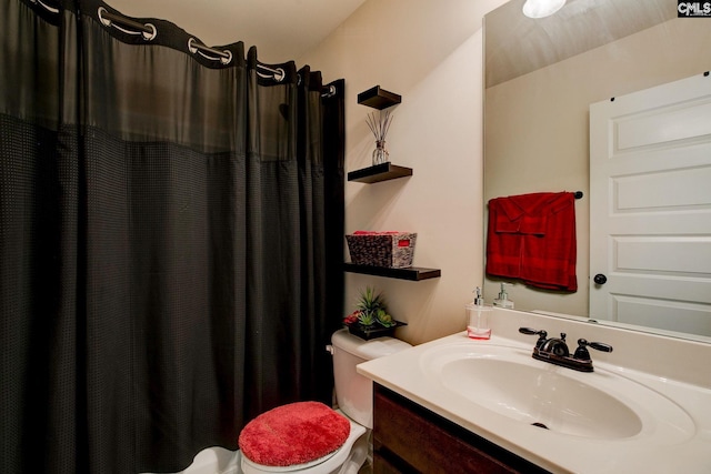 bathroom featuring toilet, a shower with shower curtain, and vanity