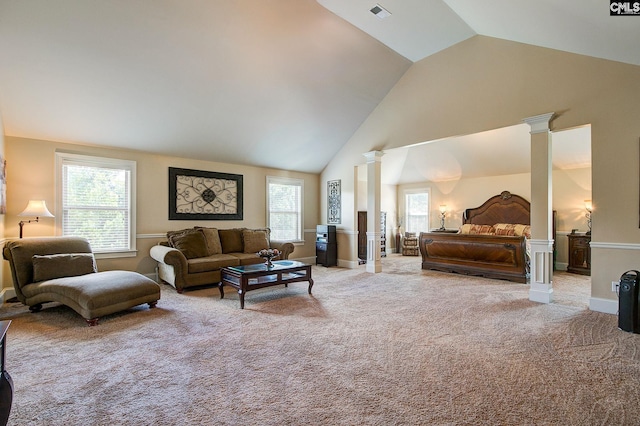 carpeted bedroom featuring multiple windows, lofted ceiling, and ornate columns