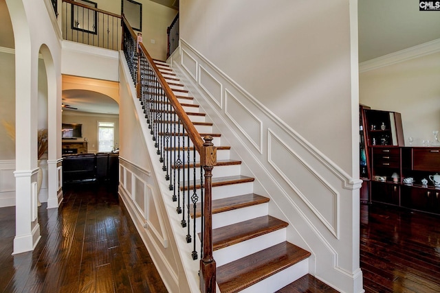 stairs featuring hardwood / wood-style flooring and crown molding