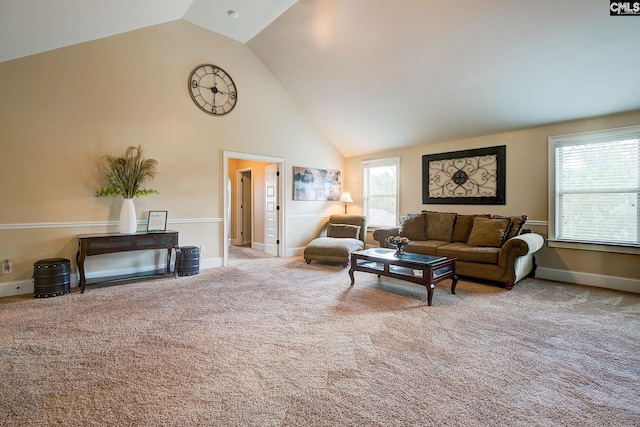 carpeted living room with high vaulted ceiling