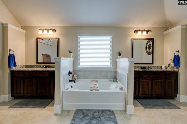 bathroom featuring vanity, a bathing tub, tile patterned flooring, and lofted ceiling
