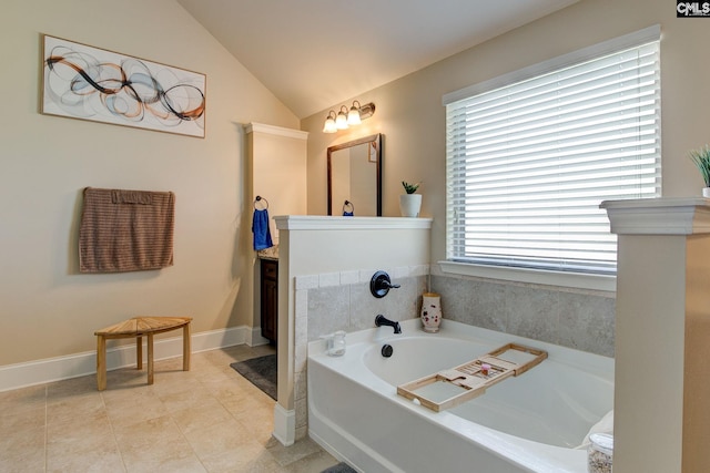 bathroom with a tub to relax in, vanity, lofted ceiling, and tile patterned flooring
