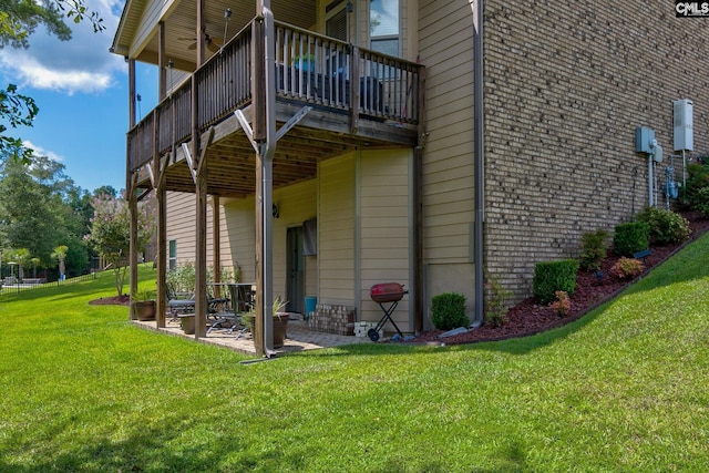 view of property exterior with ceiling fan, a patio area, and a yard