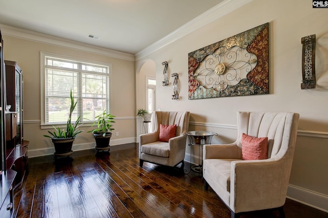 sitting room with dark hardwood / wood-style floors and crown molding