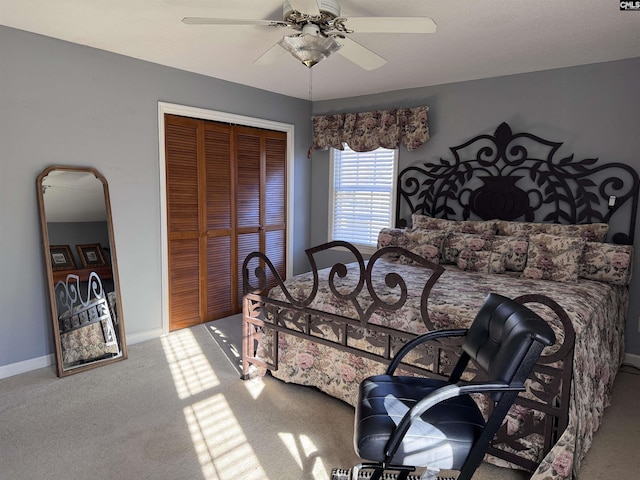 bedroom featuring ceiling fan, a closet, and carpet flooring