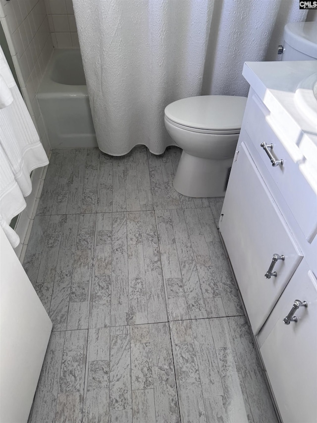 full bathroom featuring toilet, vanity, and shower / bath combination with curtain