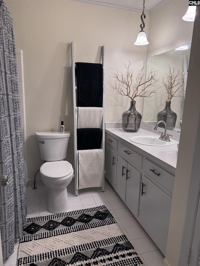 bathroom with toilet, vanity, ornamental molding, and tile patterned flooring