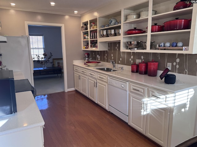 kitchen with backsplash, sink, white appliances, and white cabinets