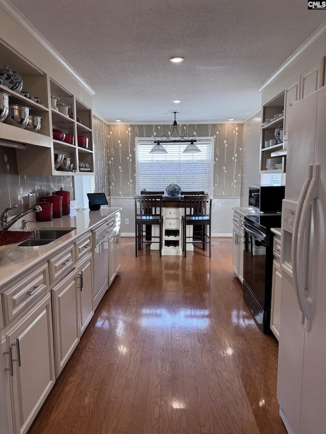 kitchen with dishwashing machine, white fridge with ice dispenser, white cabinets, a textured ceiling, and black range with electric stovetop