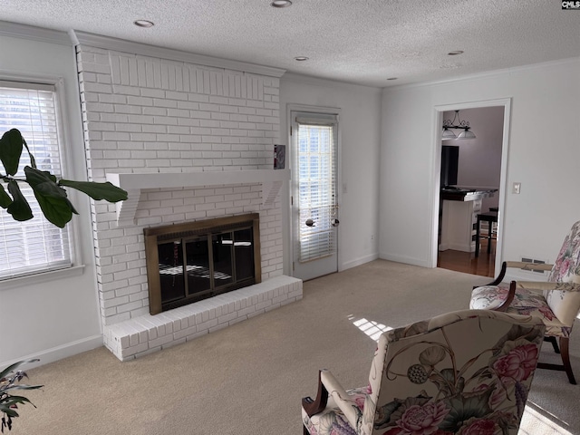 carpeted living room featuring a textured ceiling, ornamental molding, and a fireplace