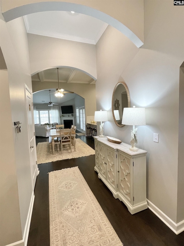 hall featuring crown molding, dark hardwood / wood-style floors, and lofted ceiling