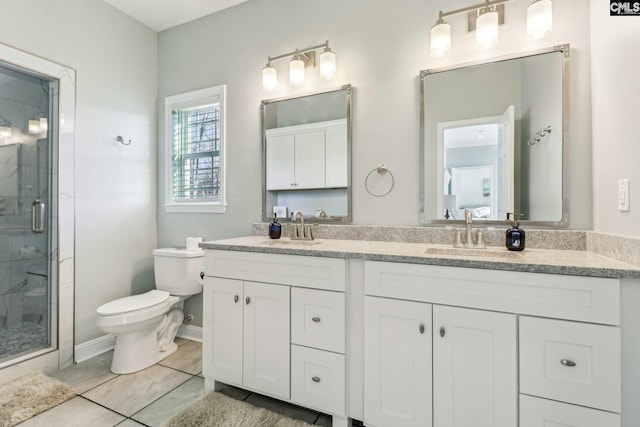 bathroom featuring an enclosed shower, vanity, toilet, and tile patterned flooring