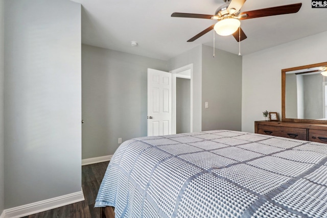 bedroom with ceiling fan and dark hardwood / wood-style flooring