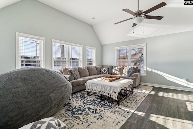 living room featuring ceiling fan, wood-type flooring, vaulted ceiling, and a healthy amount of sunlight