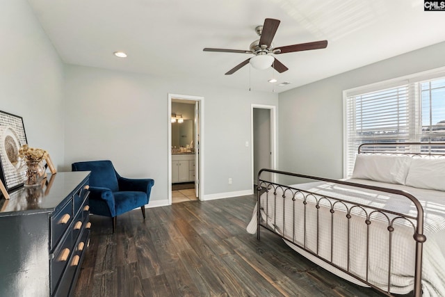 bedroom featuring dark wood-type flooring, ensuite bath, and ceiling fan