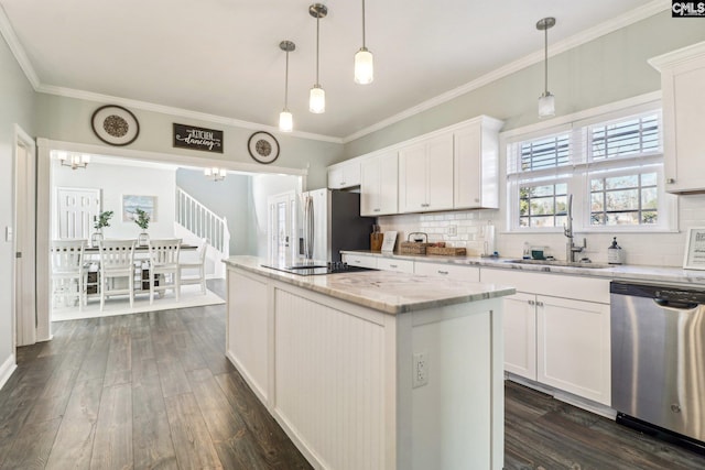 kitchen featuring white cabinets, pendant lighting, and appliances with stainless steel finishes