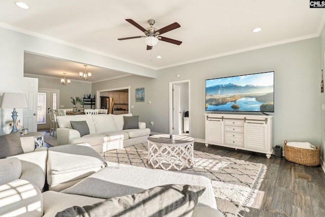 living room with crown molding, ceiling fan with notable chandelier, and dark hardwood / wood-style flooring