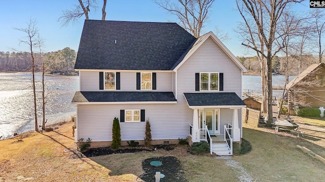 back of property featuring a water view and a yard