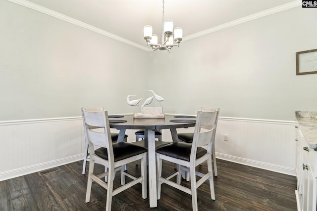 dining area featuring dark hardwood / wood-style floors and a chandelier