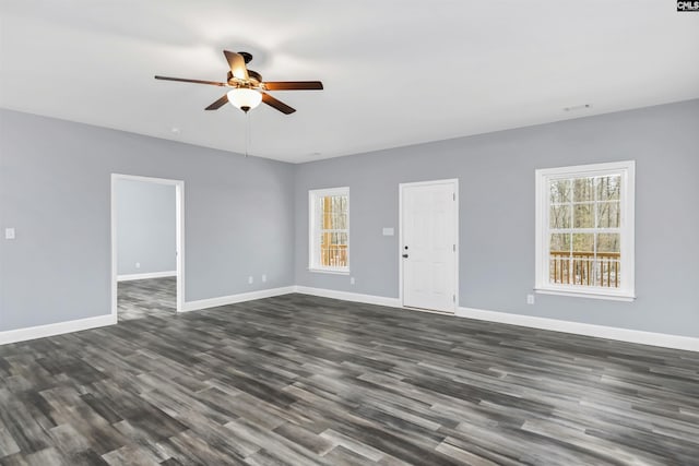 empty room featuring dark wood-type flooring and ceiling fan