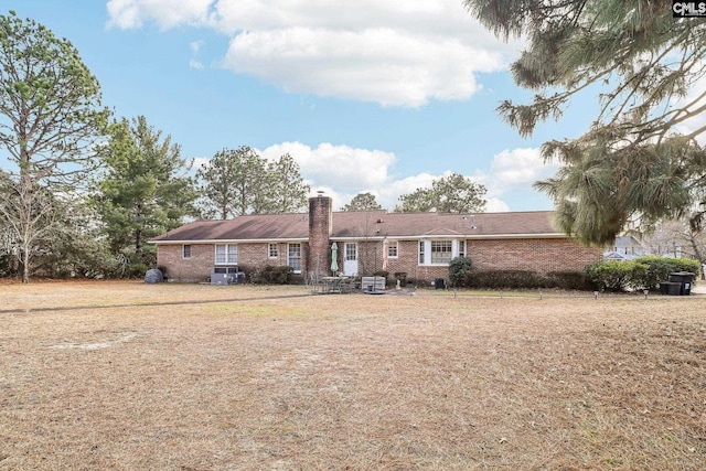 back of property featuring a lawn