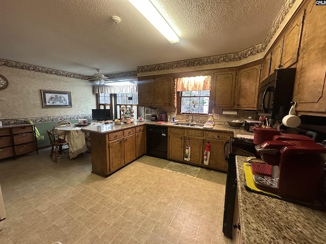 kitchen with sink, a textured ceiling, kitchen peninsula, ceiling fan, and black appliances