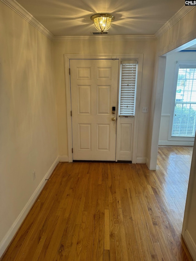 foyer entrance featuring light wood-type flooring and ornamental molding