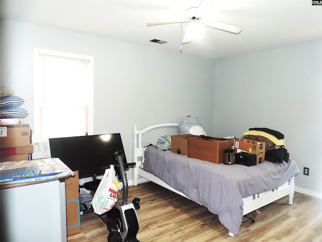 bedroom featuring ceiling fan and wood-type flooring