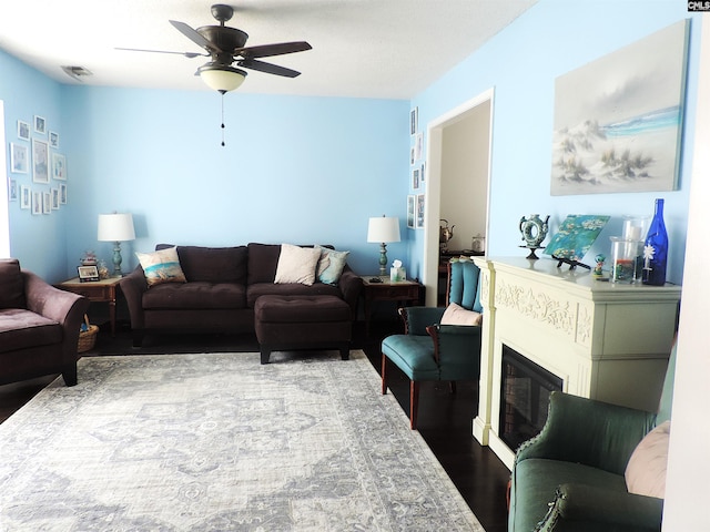 living room with ceiling fan and hardwood / wood-style floors