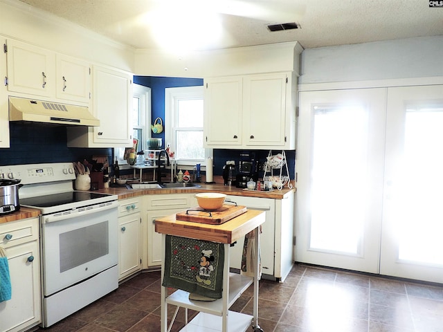 kitchen featuring sink, white cabinetry, a healthy amount of sunlight, and white range with electric cooktop