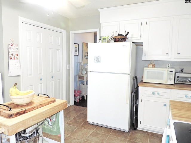 kitchen with white cabinetry and white appliances