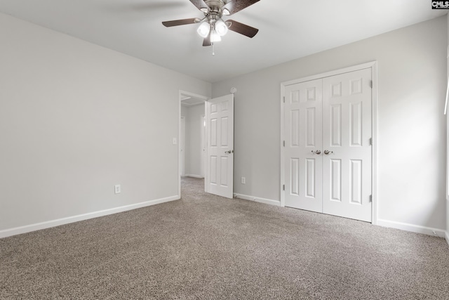 unfurnished bedroom featuring ceiling fan, a closet, and carpet