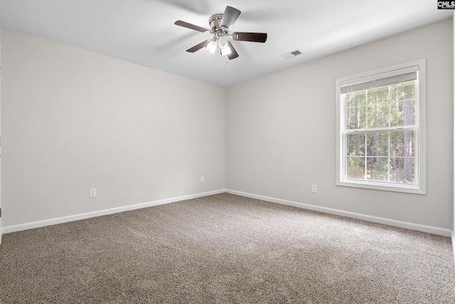 carpeted spare room featuring ceiling fan