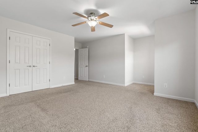 unfurnished bedroom with ceiling fan, a closet, and carpet