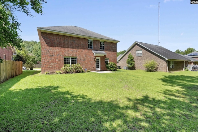 rear view of property featuring a yard