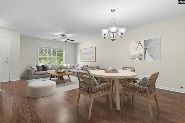 dining room with ceiling fan with notable chandelier and dark hardwood / wood-style floors