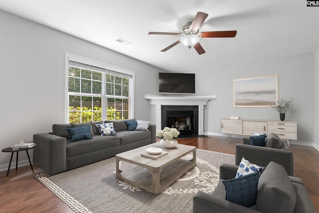 living room featuring dark hardwood / wood-style floors and ceiling fan