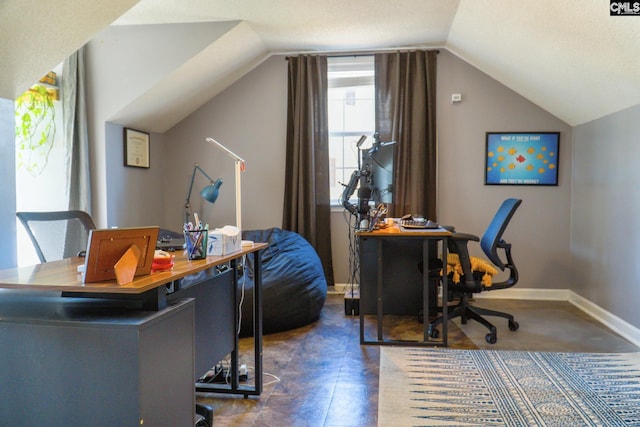 office area with vaulted ceiling