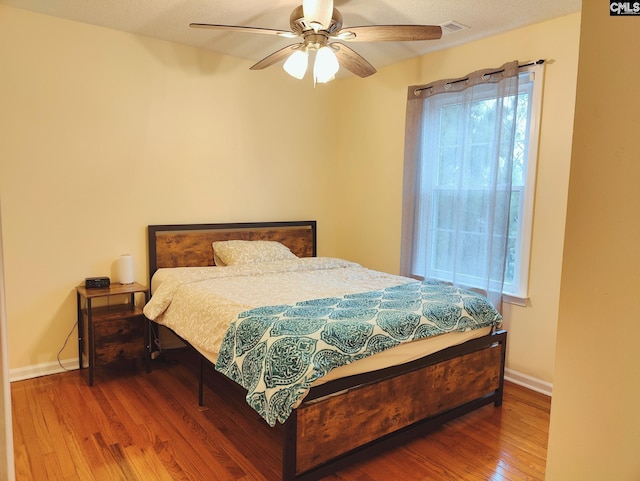 bedroom featuring hardwood / wood-style floors and ceiling fan