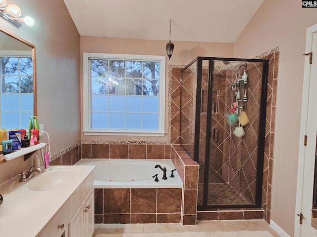 bathroom with vanity and shower with separate bathtub