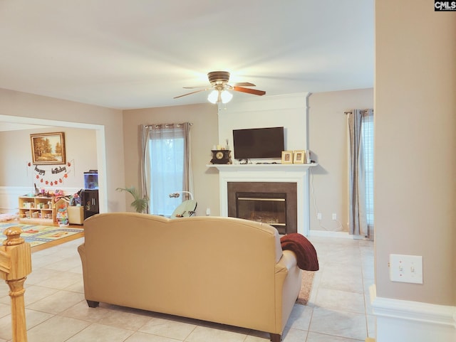 living room featuring ceiling fan and light tile patterned floors