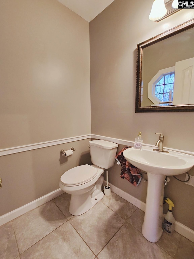 bathroom with tile patterned flooring and toilet