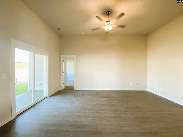 unfurnished room featuring dark wood-type flooring and ceiling fan